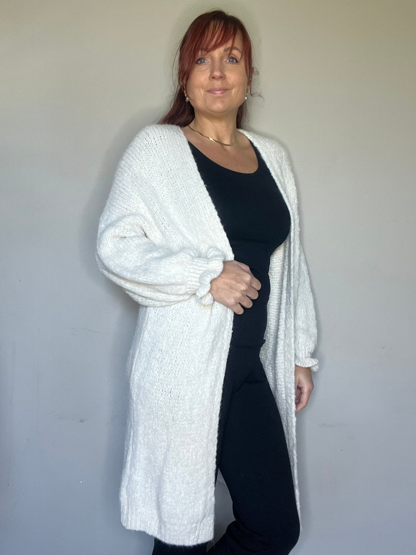 Lang vest met ruffle mouwen in groen, ecru en roze. One size tot maat 44.