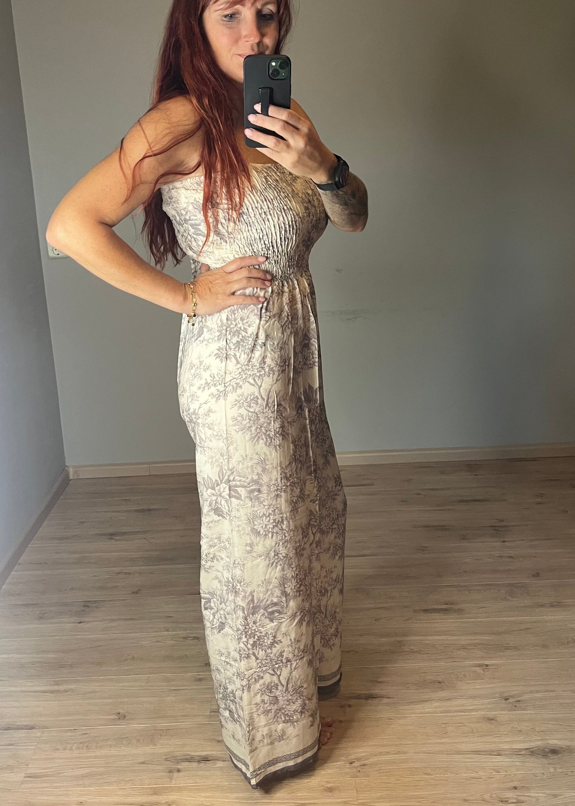 Dames jumpsuit van viscose in beige-grijze Soft Taupe Print met spaghetti bandjes en gesmokt lijfje. Verkrijgbaar in maat S, M en L.